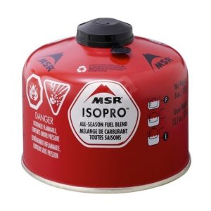 Red MSR IsoPro all-season fuel canister with black cap, safety icons and warning text for flammable fuel.