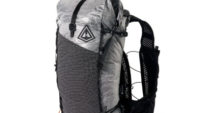 Gray hiking backpack with black straps and a breathable mesh back panel, front side pocket visible and a triangular logo on the flap