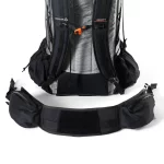 Hiking backpack with a detachable padded hip belt laid out in front, showing waist straps and pockets