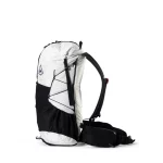 White and black hiking backpack with side pockets and crisscross bungee cords on the front panel, photographed from the side.