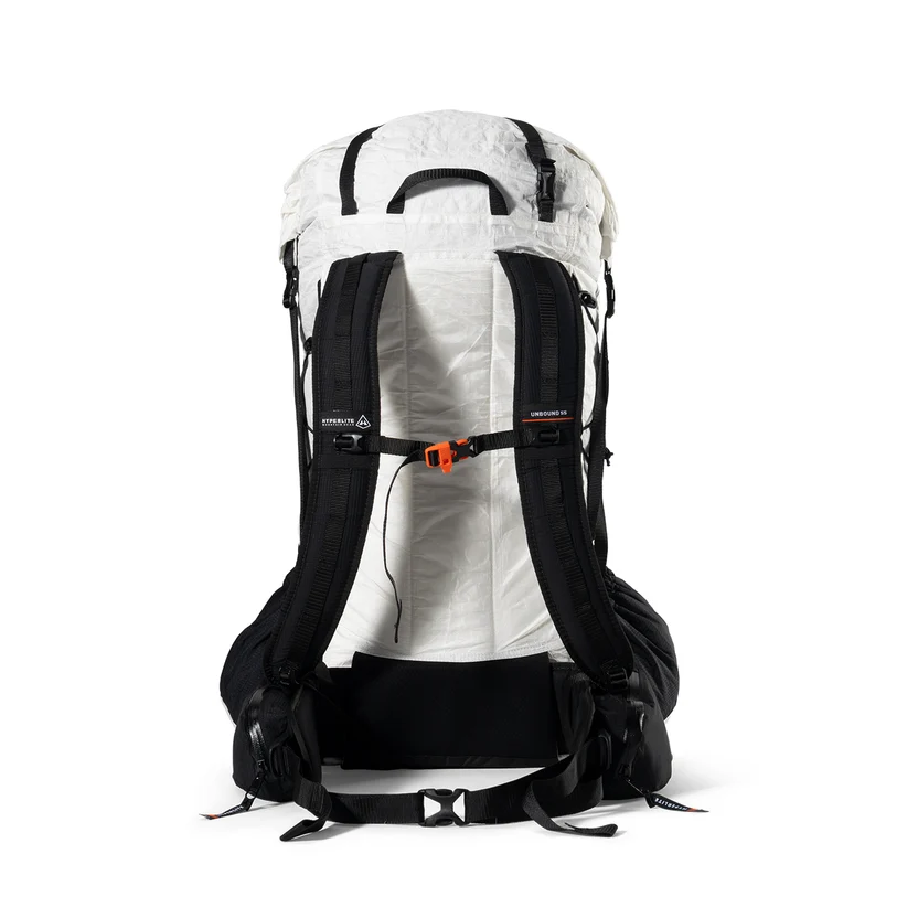 Back view of a white hiking backpack with black padded shoulder straps and an orange sternum strap.