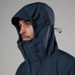 Montane Mens Norste Lite Jacket Eclipse Blue 07 Man in a navy waterproof hooded jacket, side profile with zip front and adjustable drawstring hood.