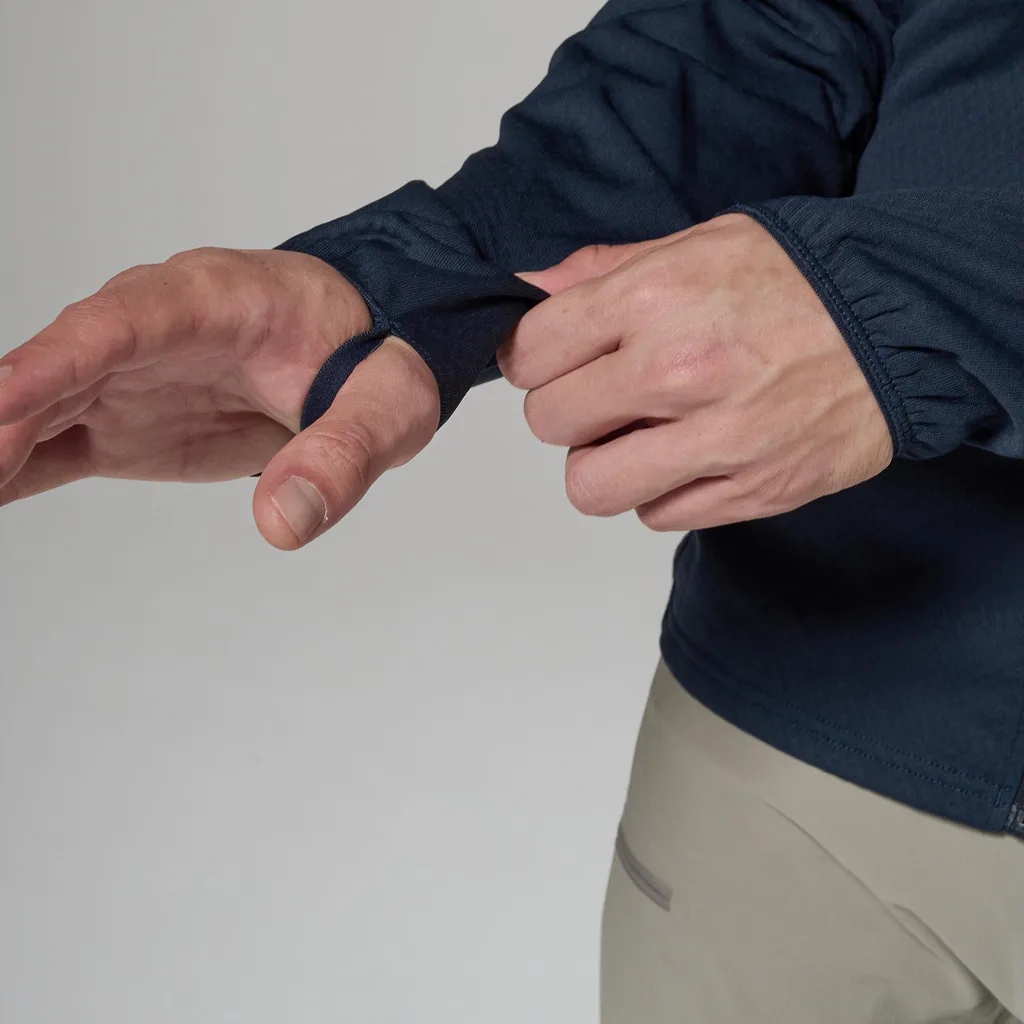 Montane Mens Zepher Jacket Eclipse Blue 05 Person in a navy jacket adjusts the cuff on their sleeve, showing a close-up of hands and forearm.