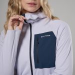 Montane Womens Zepher Hoodie Platinum 05 Woman wearing a lavender Montane jacket with a dark navy zippered chest pocket, posed adjusting the collar toward the zipper edge.
