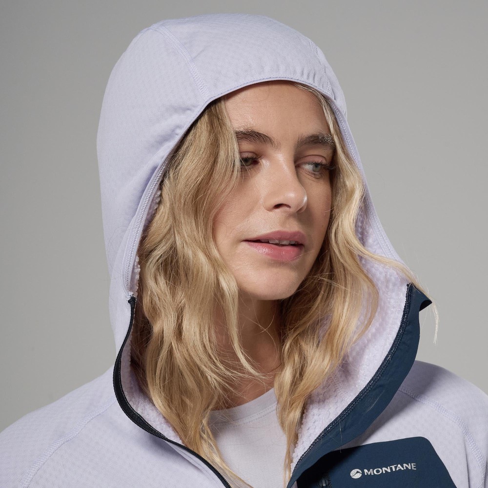 Montane Womens Zepher Hoodie Platinum 08 Close-up of a woman wearing a lavender fleece hoodie with the hood up; Montane logo visible on the chest